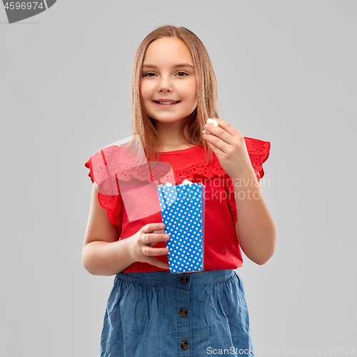 Image of beautiful smiling girl in red shirt and skirt