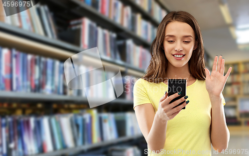 Image of smiling teenage girl having video call smartphone