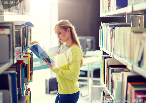 Image of high school student girl reading book at library