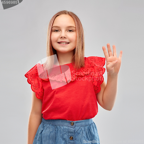 Image of smiling girl in red shirt showing four fingers