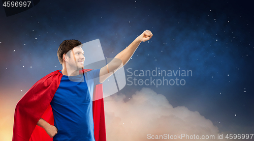 Image of man in red superhero cape over night sky