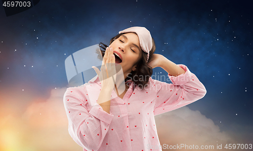 Image of happy young woman in pajama and eye sleeping mask