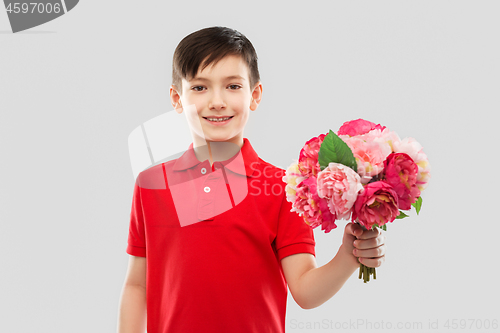 Image of smiling boy with bunch of peony flowers