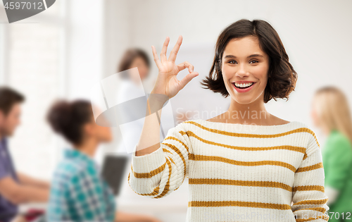 Image of happy smiling student girl showing ok at school