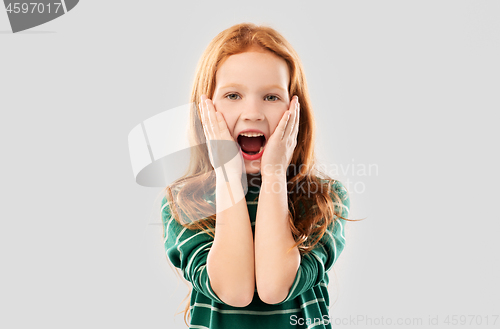 Image of shocked or surprised red haired girl screaming