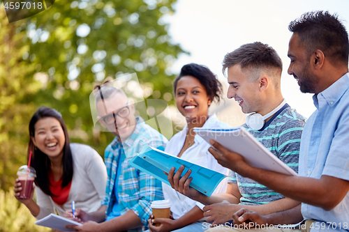 Image of group of happy students with notebooks and drinks