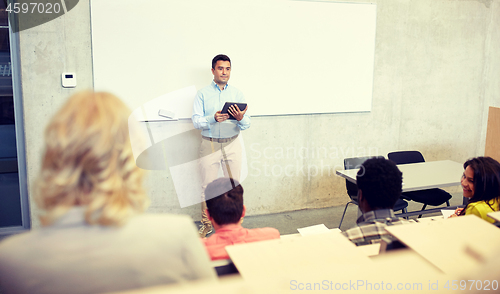 Image of students and teacher with tablet pc at lecture