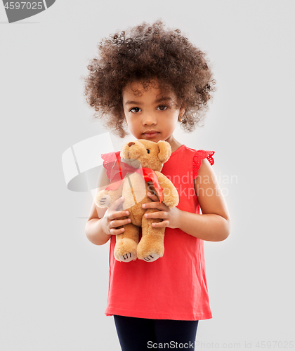 Image of sad little african american girl with teddy bear