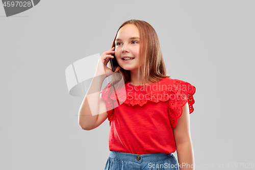 Image of beautiful smiling girl calling on smartphone