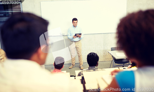 Image of students and teacher with tablet pc at lecture