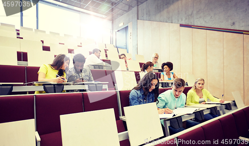 Image of group of students with notebooks at lecture hall