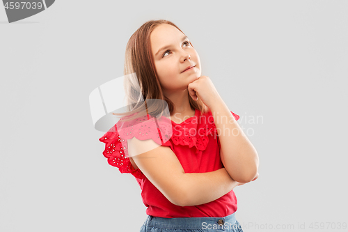 Image of beautiful girl in red shirt thinking or dreaming