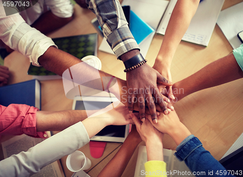 Image of close up of international students hands on top