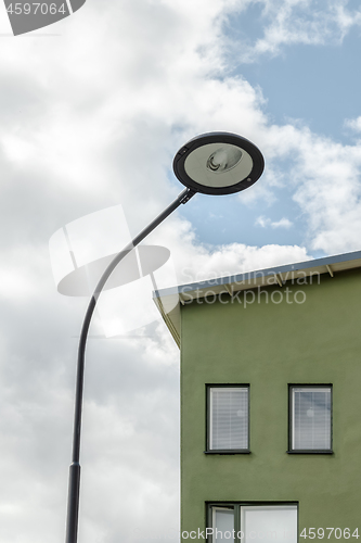 Image of Streetlamp and facade of a green house