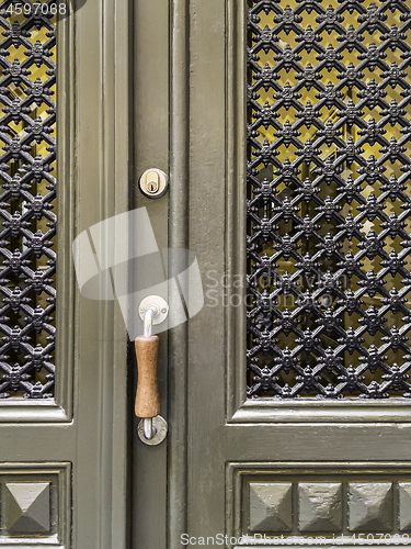 Image of Green door with ornamental windows