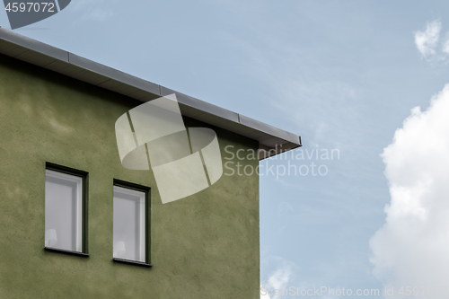 Image of Green house against blue sky