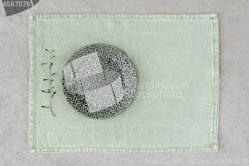 Image of Green ceramic plate on linen placemat
