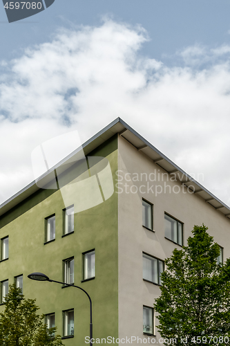 Image of Corner of a green building and trees