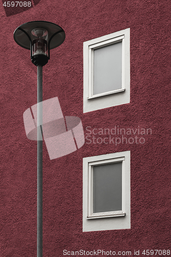 Image of Streetlamp in front of a dark red building