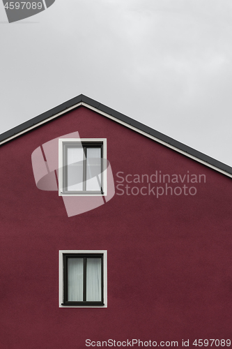 Image of Facade and roof of a dark red house