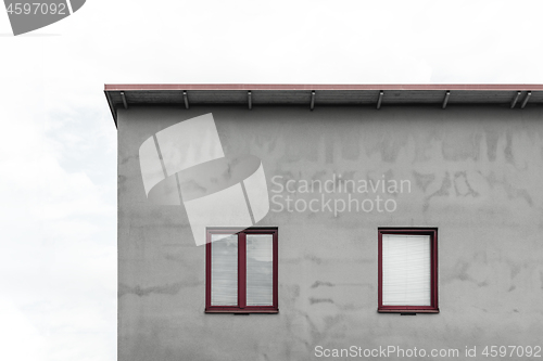 Image of Facade of a gray house with red windows