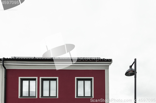 Image of Streetlamp near a modern red building