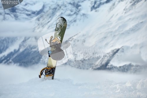 Image of Snowboard high up in the snowy Alps