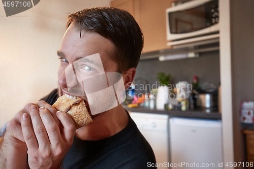 Image of Man biting a sandwich