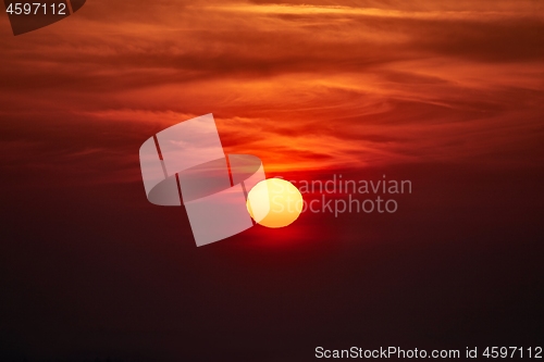 Image of Sunset through cloudy red sky