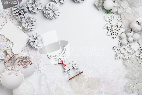 Image of Christmas decorative composition of toys on a white background surrealism. Top view