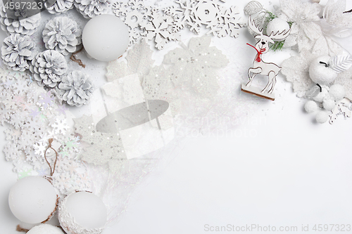 Image of Christmas decorative composition of toys on a white background surrealism. Top view