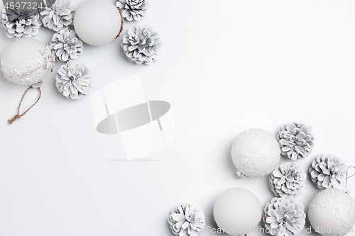 Image of Christmas decorative composition of toys on a white background surrealism. Top view