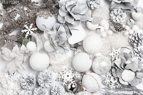 Image of Christmas decorative composition of toys on a white background surrealism. Top view