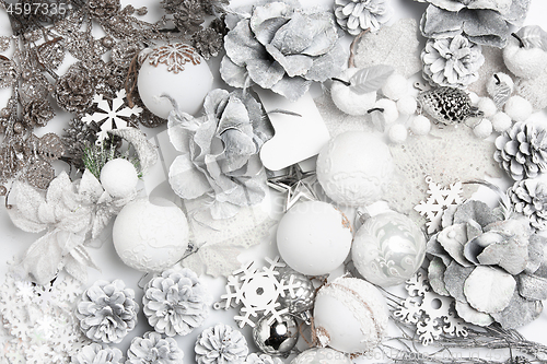 Image of Christmas decorative composition of toys on a white background surrealism. Top view