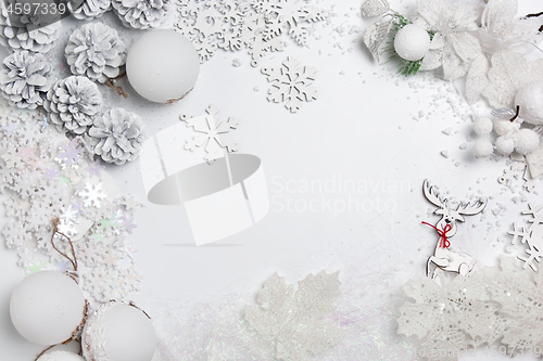 Image of Christmas decorative composition of toys on a white background surrealism. Top view