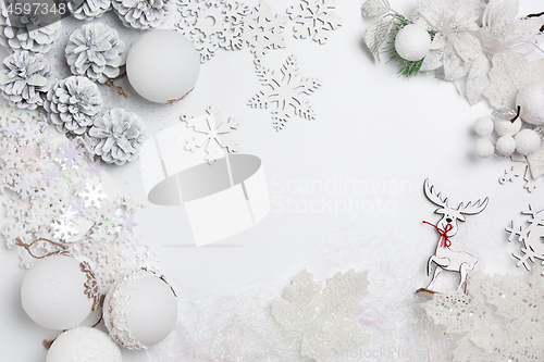 Image of Christmas decorative composition of toys on a white background surrealism. Top view