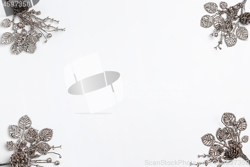 Image of Christmas decorative composition of toys on a white background surrealism. Top view