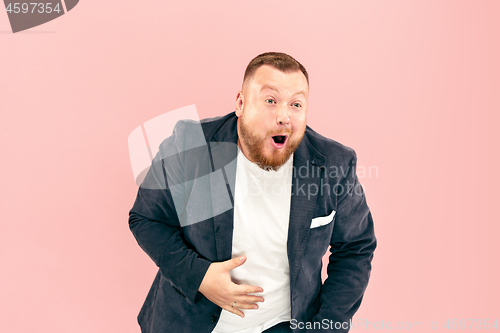 Image of Young man with microphone on pink background, leading with microphone