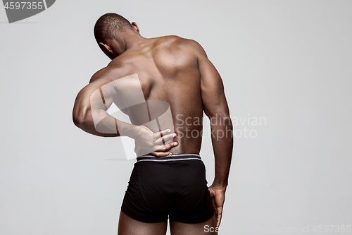 Image of Young man with back pain isolated on white