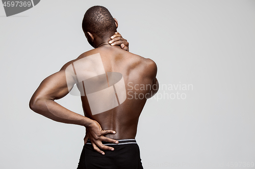 Image of Studio shot of man with pain in neck