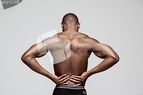 Image of Young man with back pain isolated on white