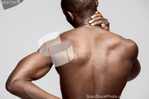 Image of Studio shot of man with pain in neck