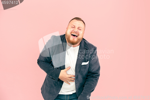 Image of Young man with microphone on pink background, leading with microphone