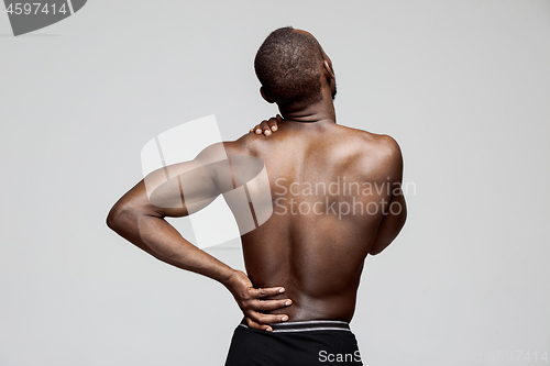 Image of Young man with back pain isolated on white