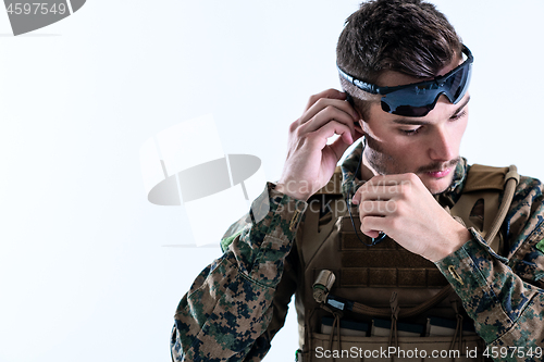 Image of soldier preparing gear for action