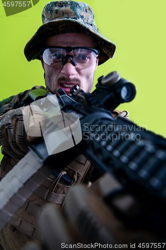 Image of soldier in action aiming laseer sight optics green background