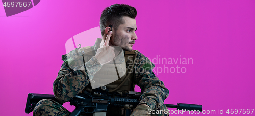 Image of soldier preparing gear for action and checking communication