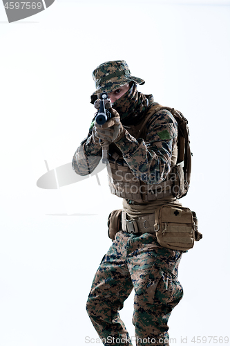 Image of soldier in action aiming laseer sight optics