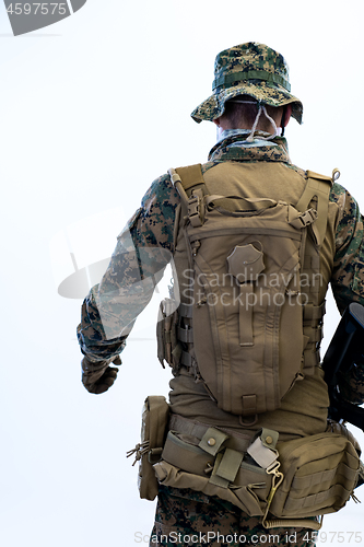 Image of soldier going in battle rear view