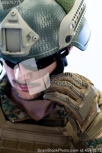 Image of soldier preparing gear for action